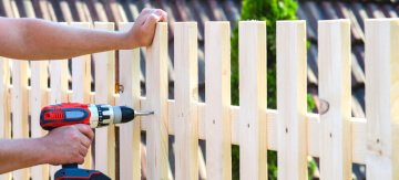 A man repairing a fence