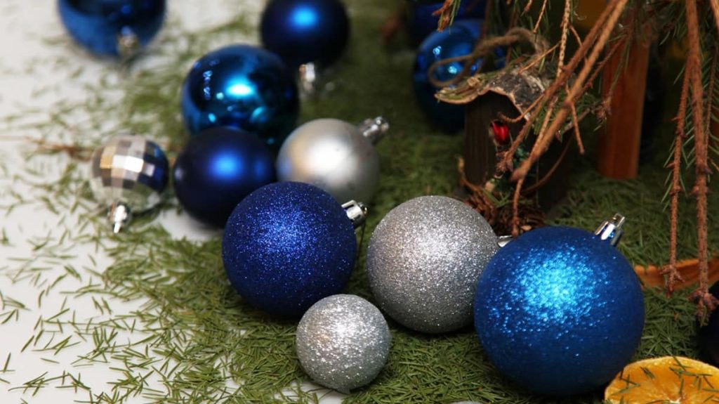 Tree sap on the floor and a few scattered blue Christmas decorations add to the holiday chaos.