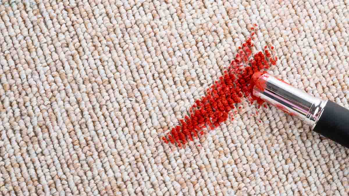 Red lipstick on carpet fibres.