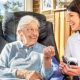 Domestic assistant and an elderly woman smiling