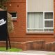 For lease and leased sign on a black display outside of residential apartment building